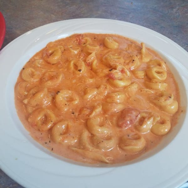 Niki's Pizza & Pasta's tortellini pasta in a creamy pink sauce with specks of pepper.